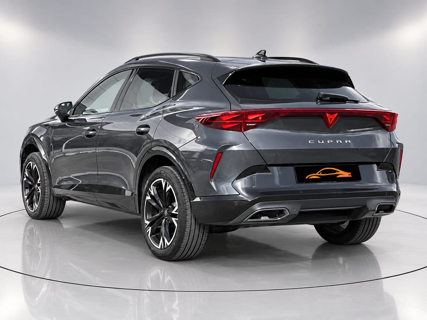 CUPRA Terramar V1 in dark grey, rear three-quarter view with full-width light bar and copper CUPRA badge