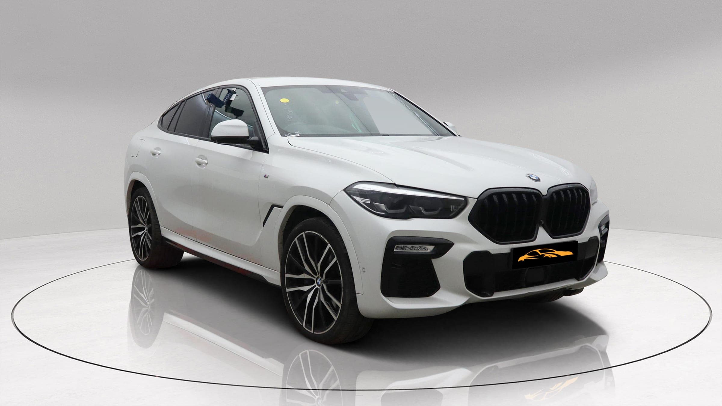 BMW X6 xDrive30d M Sport in white, front three-quarter view with M Sport bumper and black grille