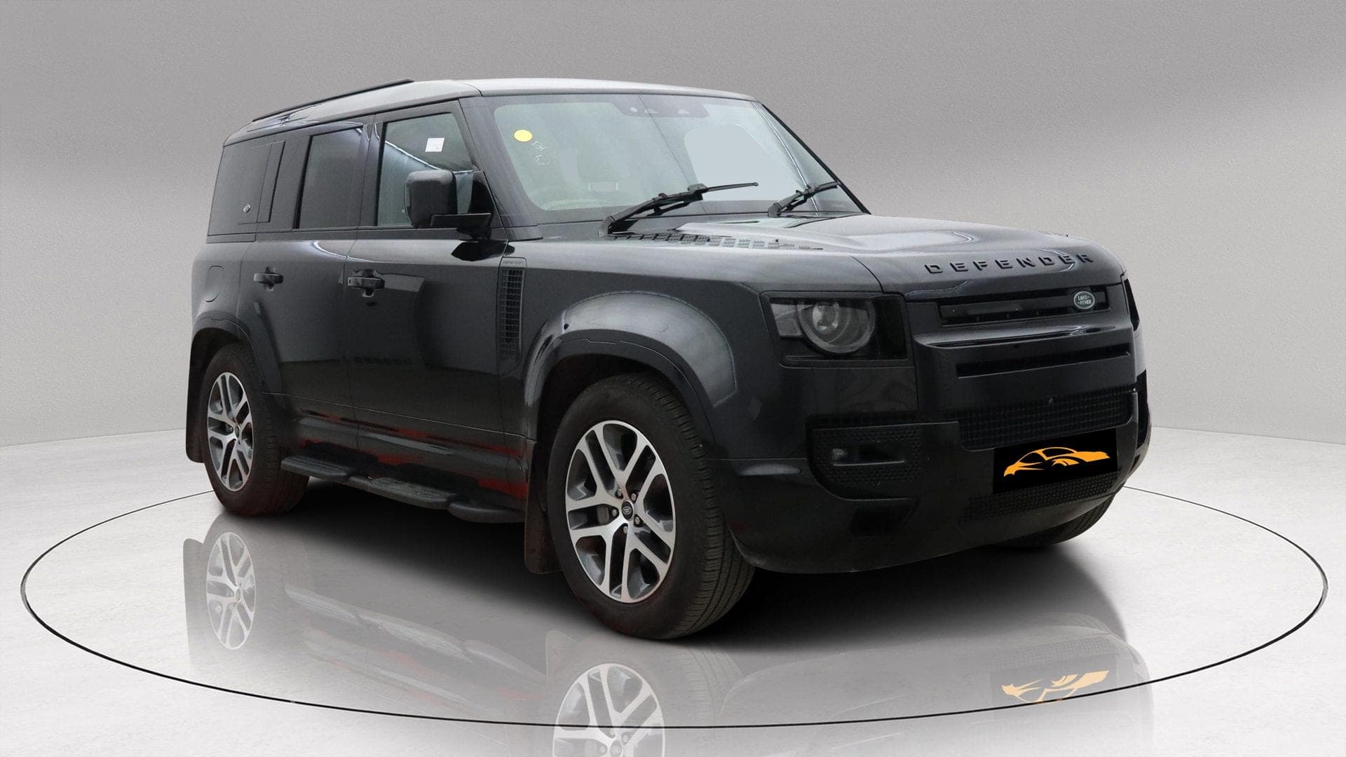 Land Rover Defender 110 P400e XS Edition in black, front three-quarter view