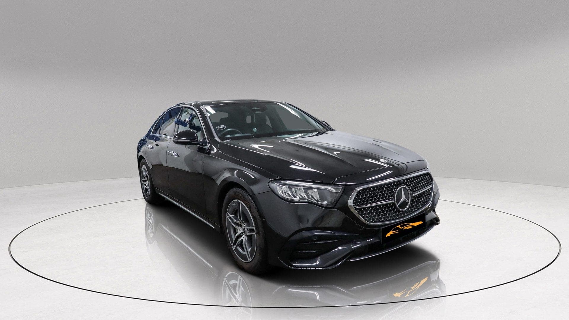 Mercedes-Benz E200 AMG Line in black — front three-quarter view